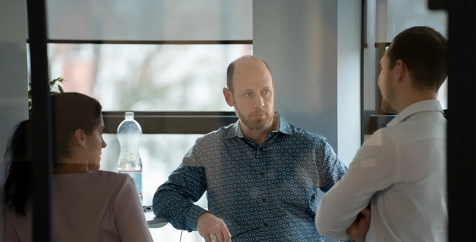 Three people are having a serious conversation.